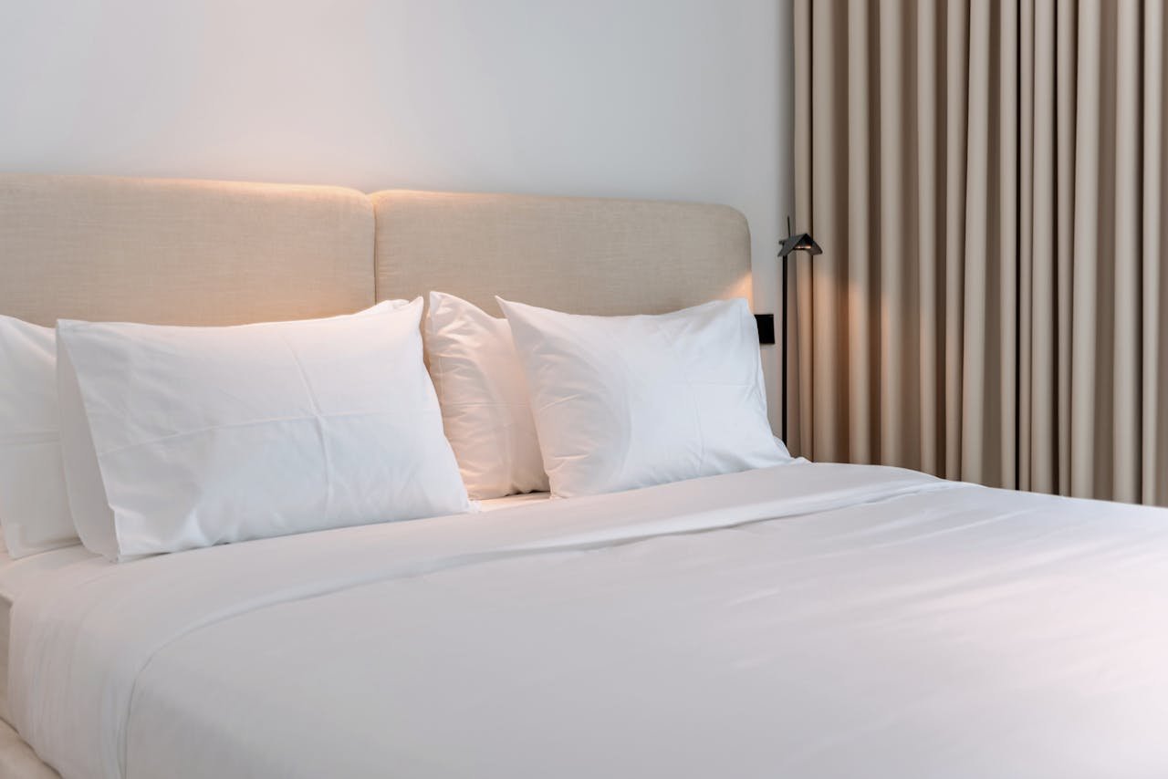 Inviting modern bedroom with beige accents, perfect for a cozy vacation rental stay.